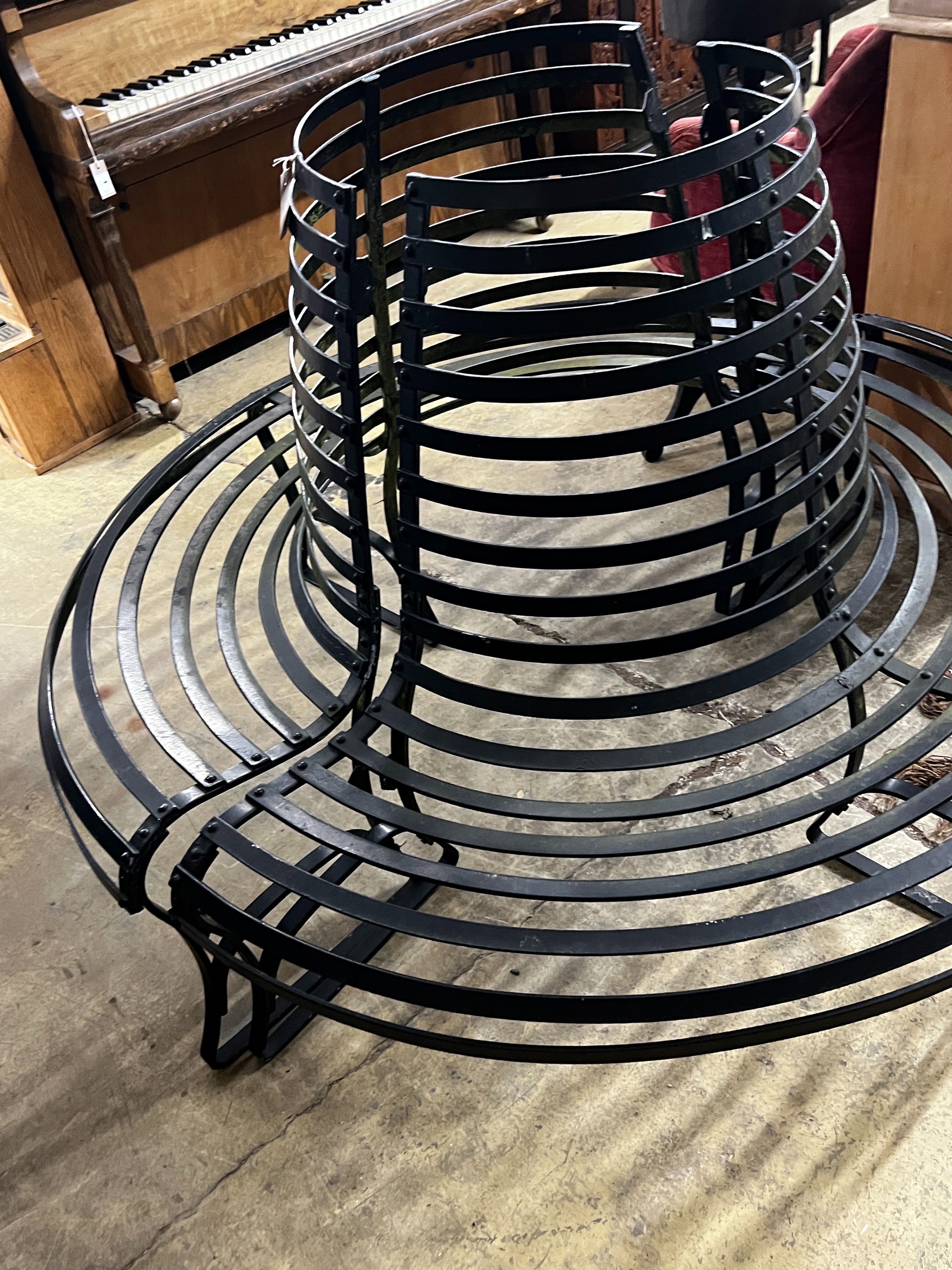 A painted wrought iron two section circular tree seat, diameter 150cm, height 100cm, minimum internal diameter 46cm